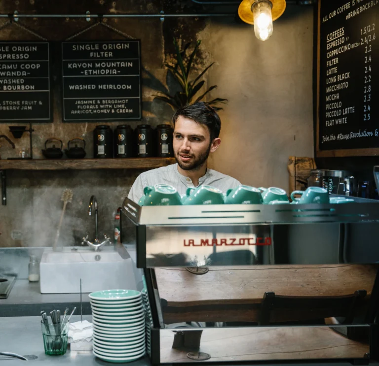 Making coffee for customer behind counter