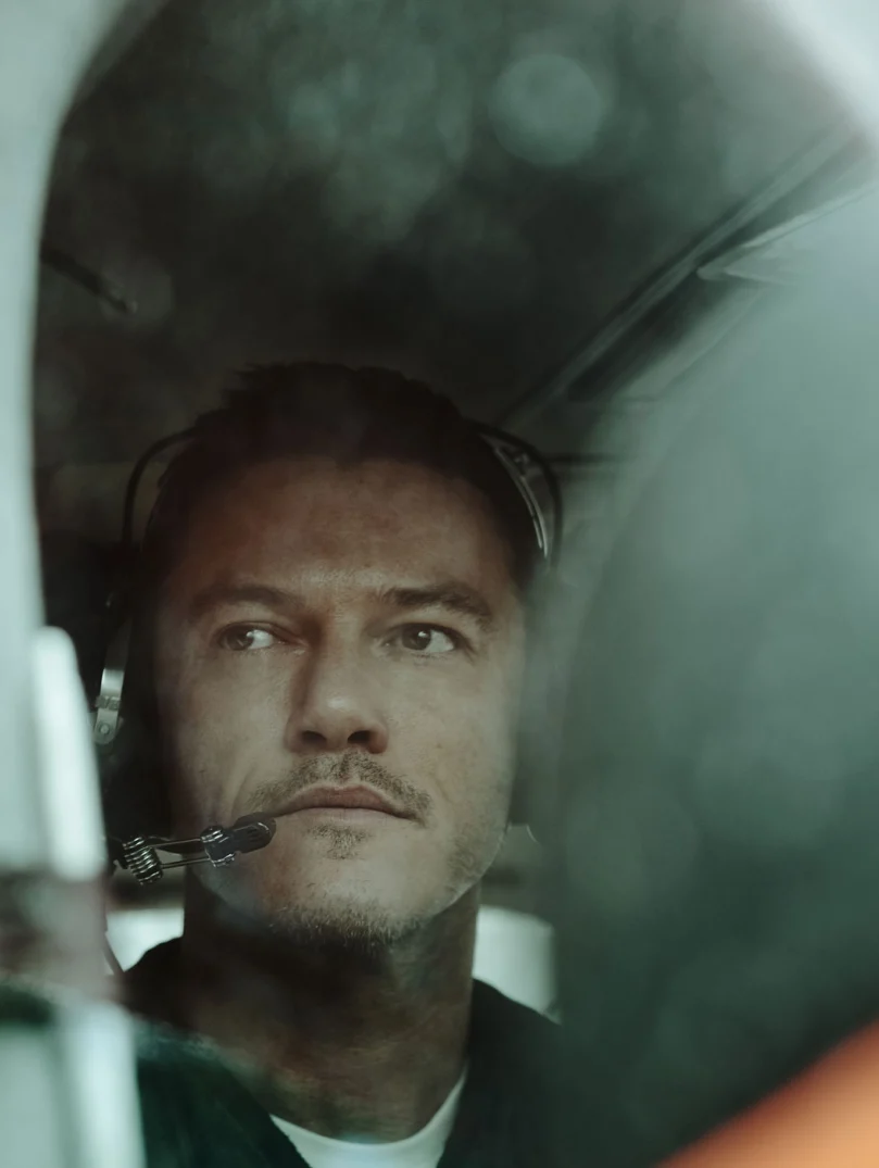Luke Evans in small plane with headset, ready for takeoff